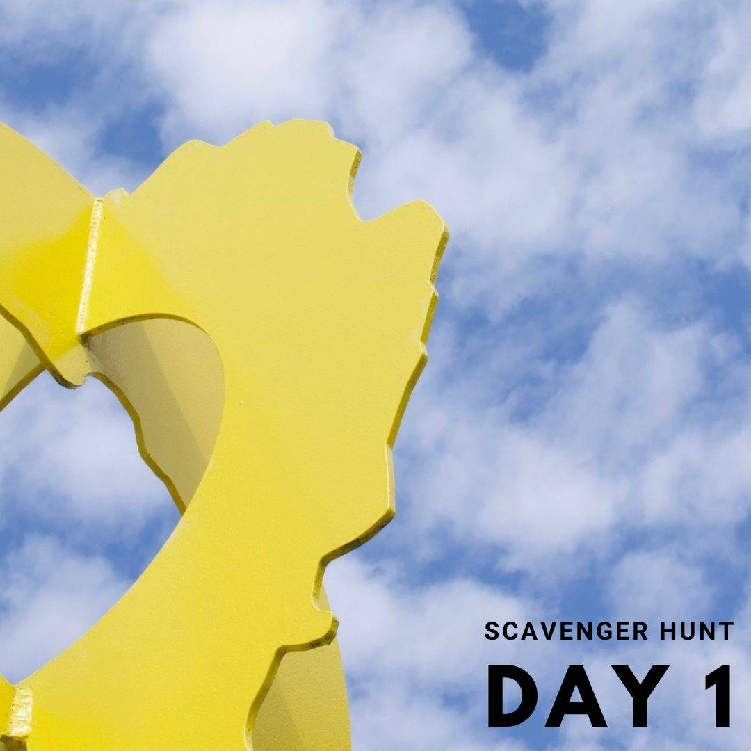 Scavenger Hunt Hint of abstract yellow metal with blue sky and clouds in the background